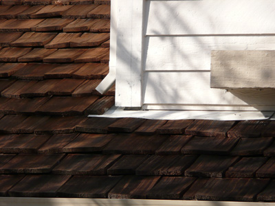 Cedar Roof meets wall with proper flashing installed - Superior method that will prevent leaks and damage 