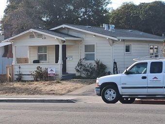 Completed roof replacement in Berkeley with the Sustainable Roofing Solutions truck outside